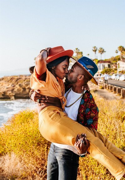 socal-standard-black-love-black-couple-bougie-burning-man-stylish-black-girl-magic-gold-pants-wood-fedora-sunset-cliffs-san-diego-couples-shoot-jeep-afropunk-marriage (1)